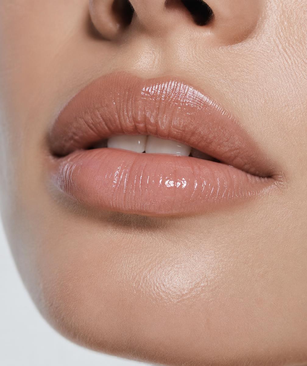 Close-up beauty photograph of an adult's lips with a natural gloss